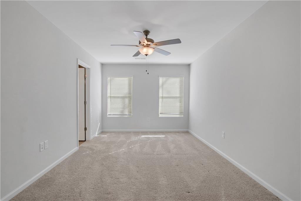 102 Jaxton Street Hoschton, GA 30548 - Photo 20 of 36 an empty room with windows and fan