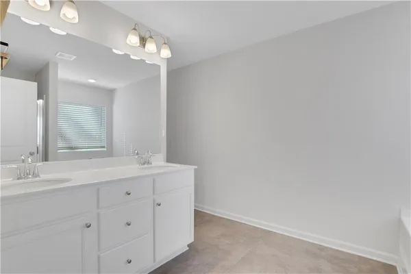 a bathroom with a double vanity sink and a mirror