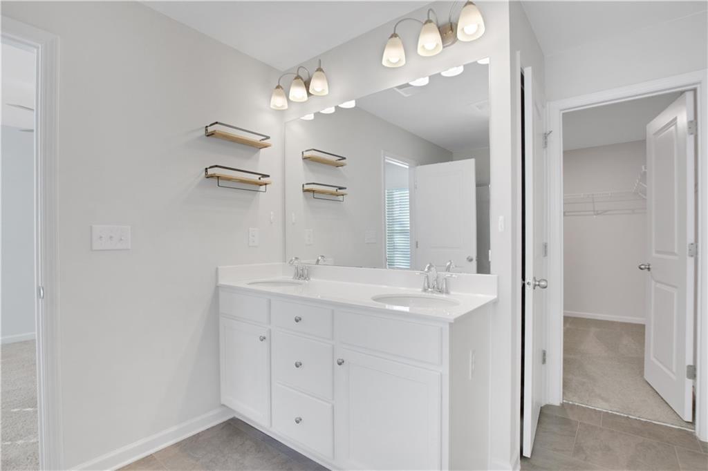 102 Jaxton Street Hoschton, GA 30548 - Photo 24 of 36 a bathroom with a sink double vanity and a mirror