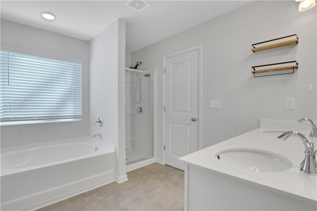 102 Jaxton Street Hoschton, GA 30548 - Photo 25 of 36 a bathroom with a sink and a bathtub