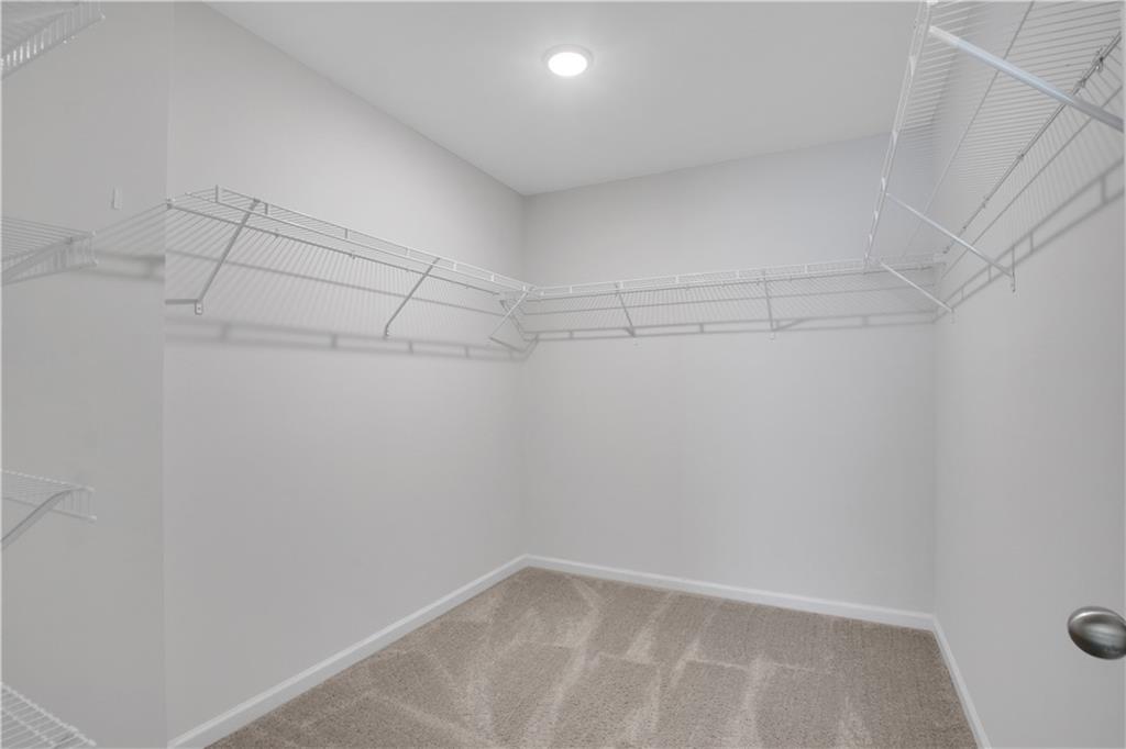 102 Jaxton Street Hoschton, GA 30548 - Photo 26 of 36 a view of a room with racks on the wall