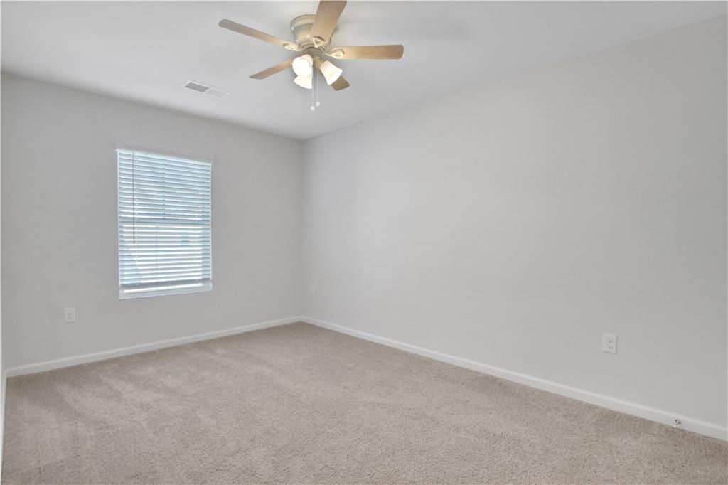 102 Jaxton Street Hoschton, GA 30548 - Photo 29 of 36 an empty room with a window and a fan