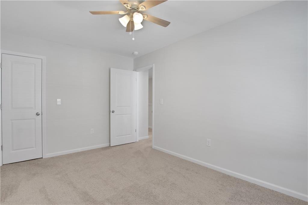 102 Jaxton Street Hoschton, GA 30548 - Photo 30 of 36 an empty room with a chandelier fan