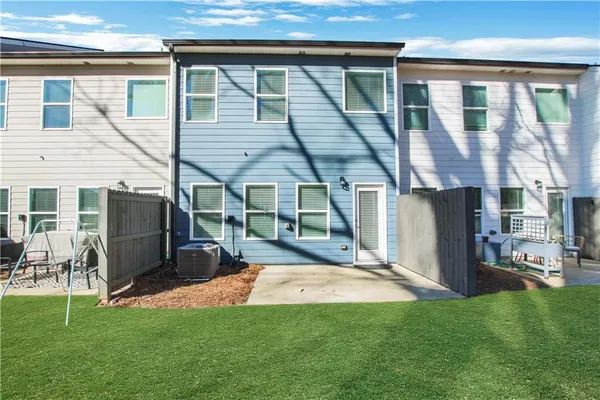 a view of a house with backyard porch and sitting area