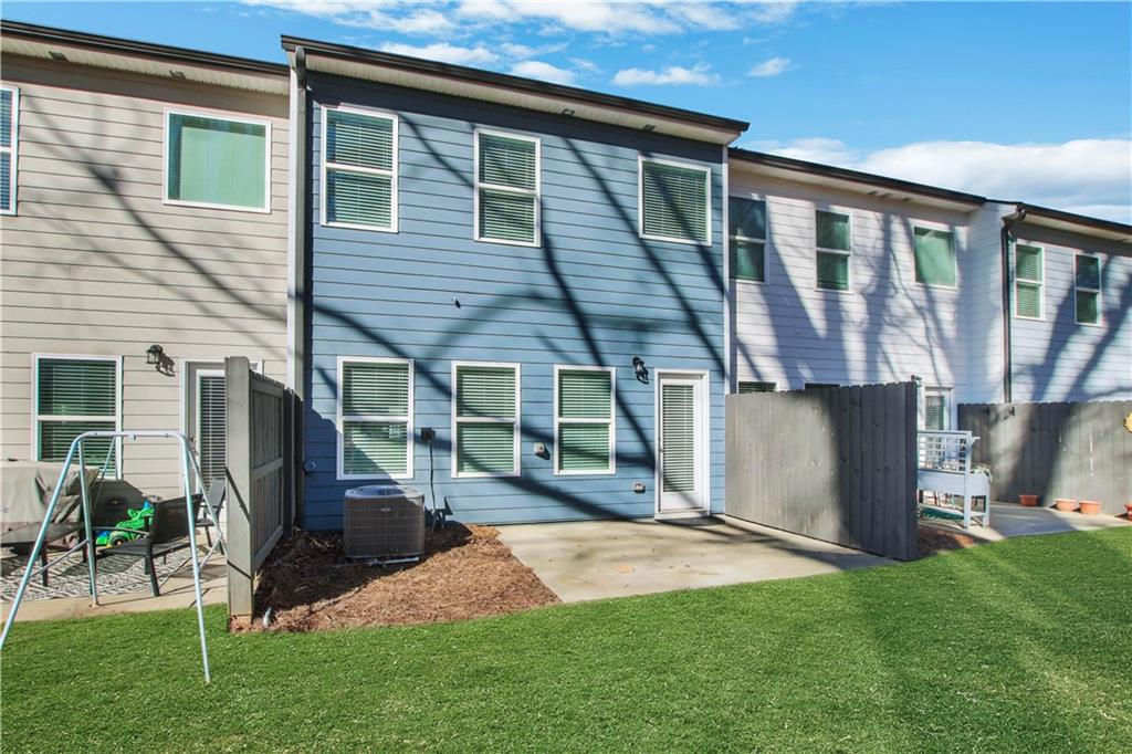 102 Jaxton Street Hoschton, GA 30548 - Photo 35 of 36 a view of a house with backyard and a patio