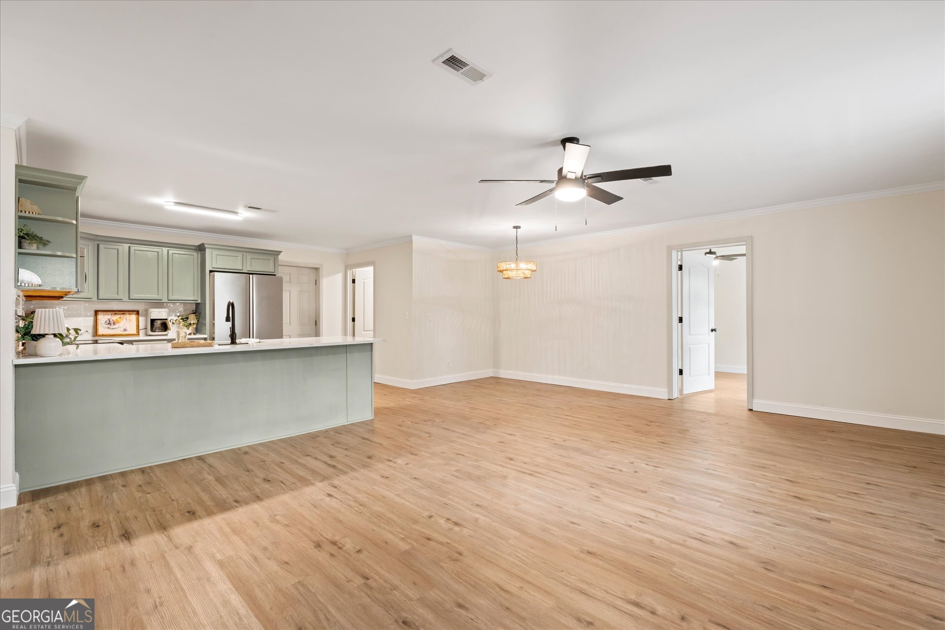 269 Eldred Street Lineville, AL 36266 - Photo 11 of 11 wooden floor in an empty room with a kitchen