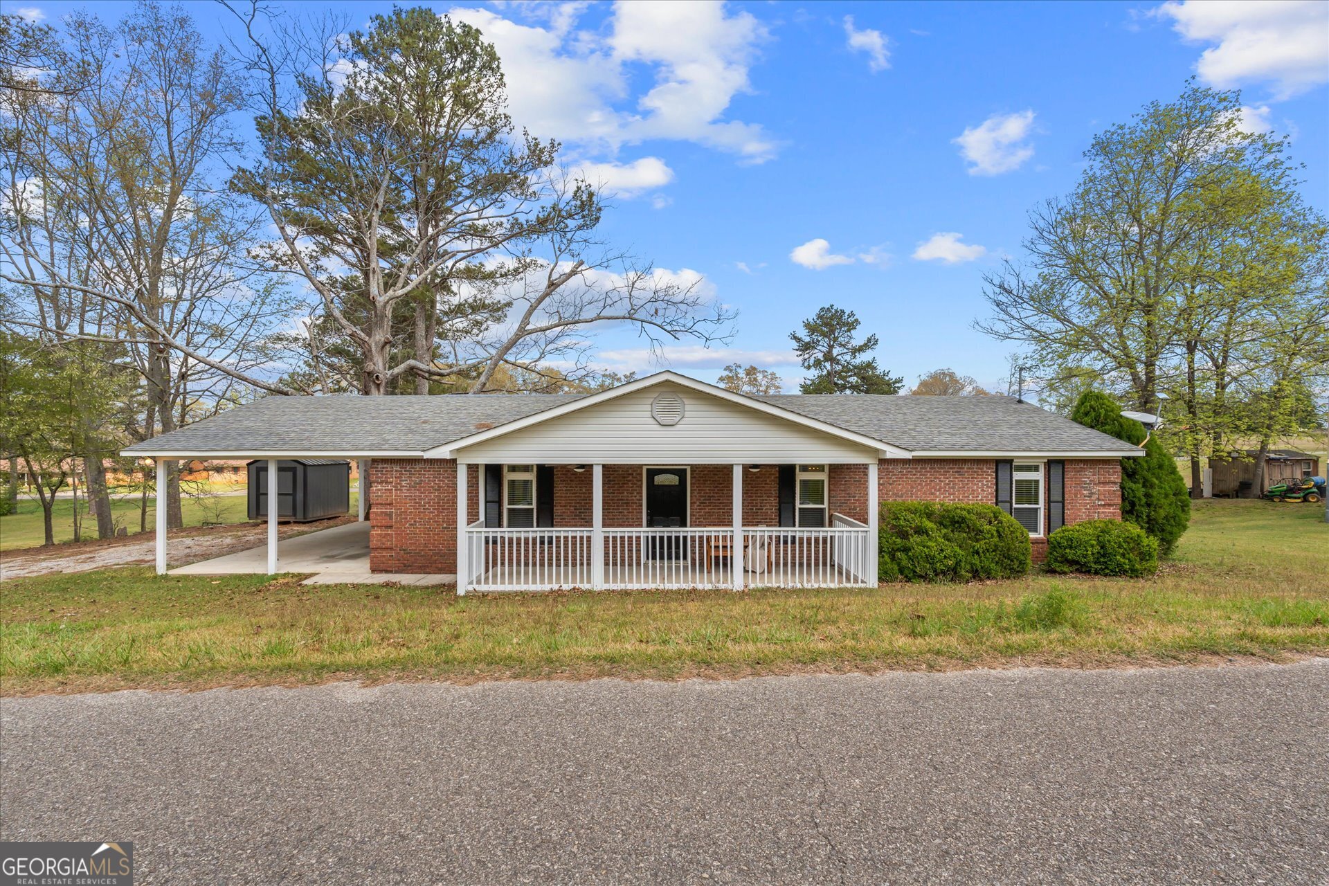 269 Eldred Street Lineville, AL 36266 - Photo 5 of 11 a front view of a house with a garden and trees