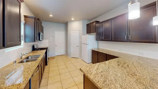 a bathroom with a granite countertop sink and mirror
