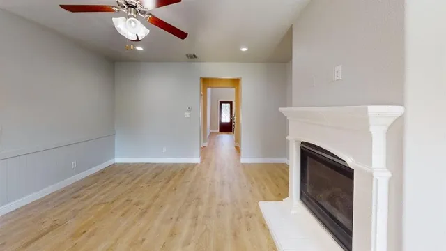 wooden floor in an empty room with a fireplace