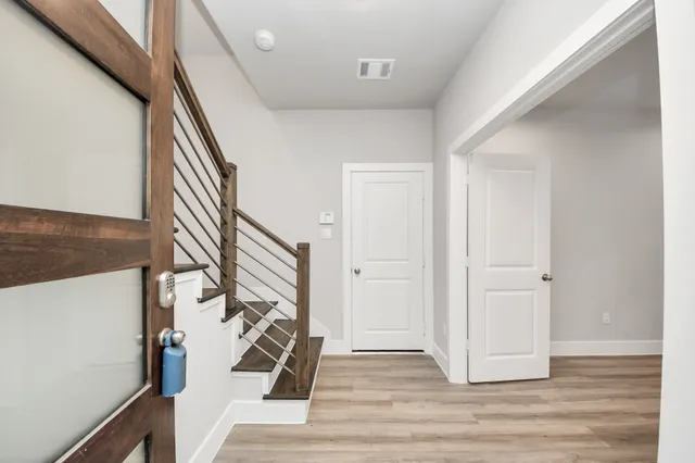 a view of an entryway with wooden floor