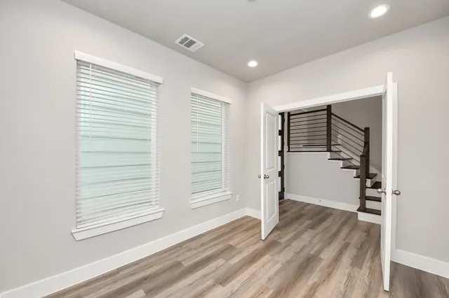 a view of wooden floor and windows in a room