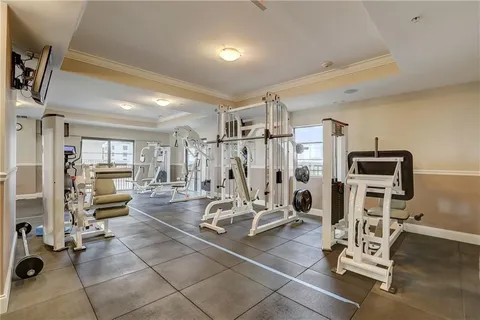 a view of a living room with a white table and a painting on the wall