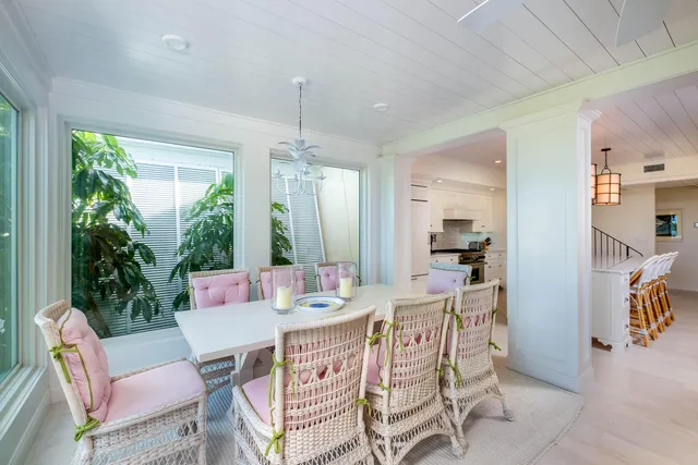 a bedroom with furniture and a large window