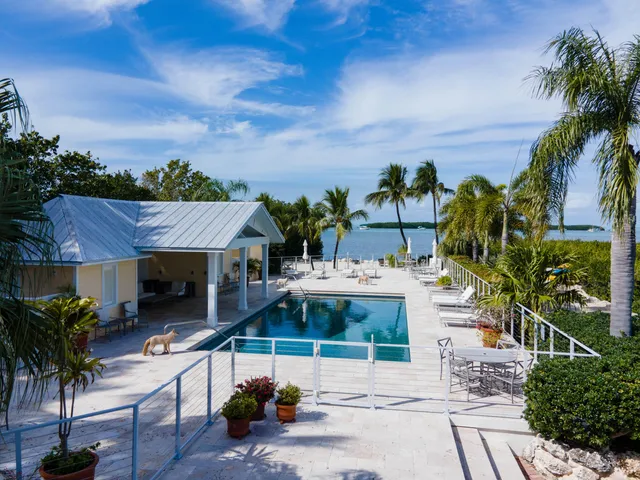 a living room with furniture a flat screen tv and a window