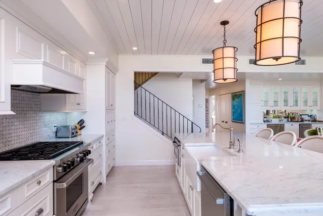 a kitchen with furniture and a flat screen tv