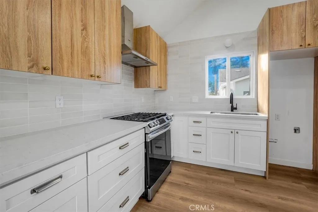 869 East Howard Street Pasadena, CA 91101 - Photo 1 of 13 a kitchen with white cabinets and sink