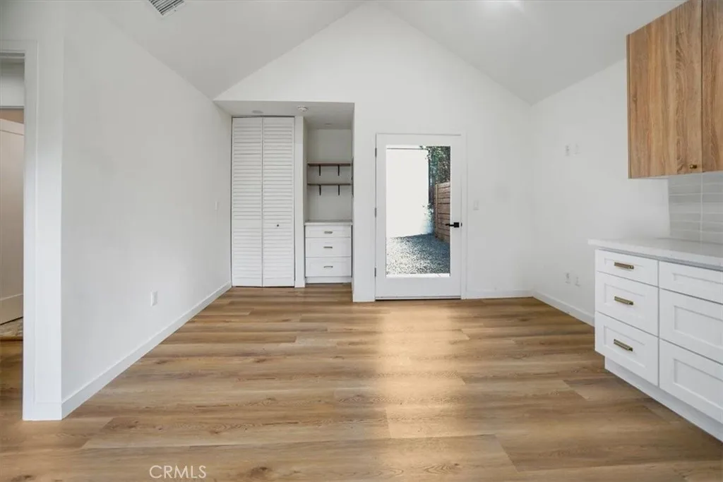 869 East Howard Street Pasadena, CA 91101 - Photo 11 of 13 a view of an empty room with window and wooden floor