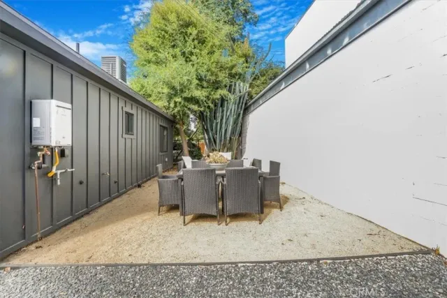 a backyard of a house with table and chairs
