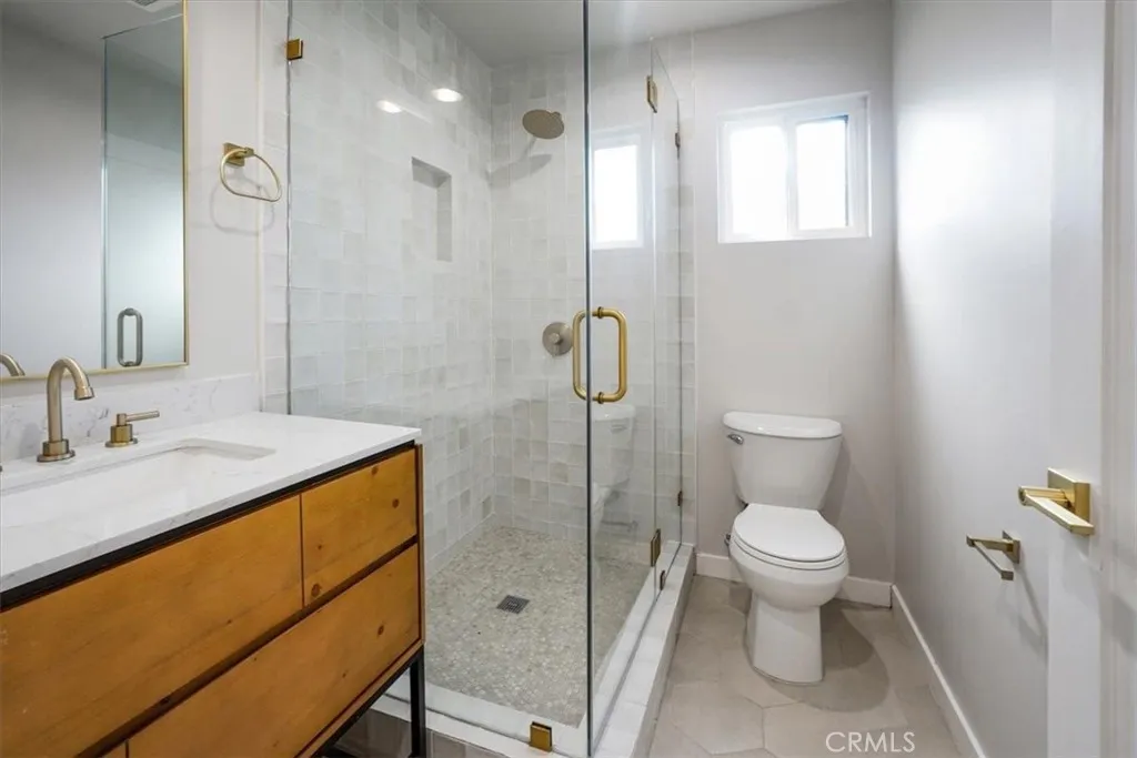869 East Howard Street Pasadena, CA 91101 - Photo 2 of 13 a bathroom with a granite countertop sink toilet and shower