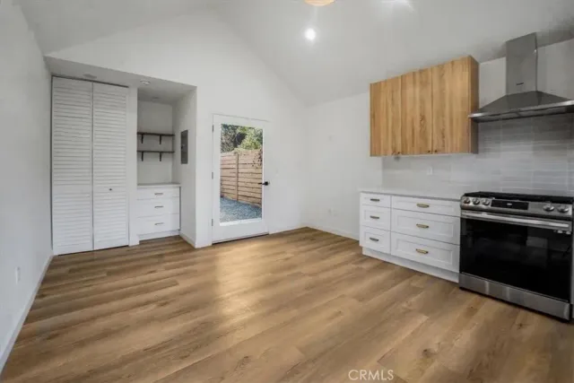 a view of a kitchen with granite countertop a stove top oven a sink and dishwasher