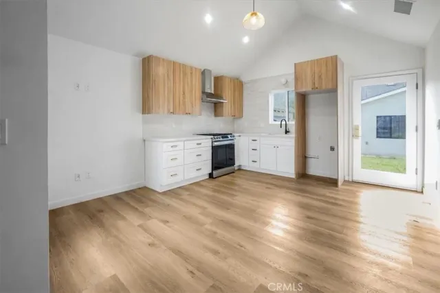 a room with a dresser and chandelier