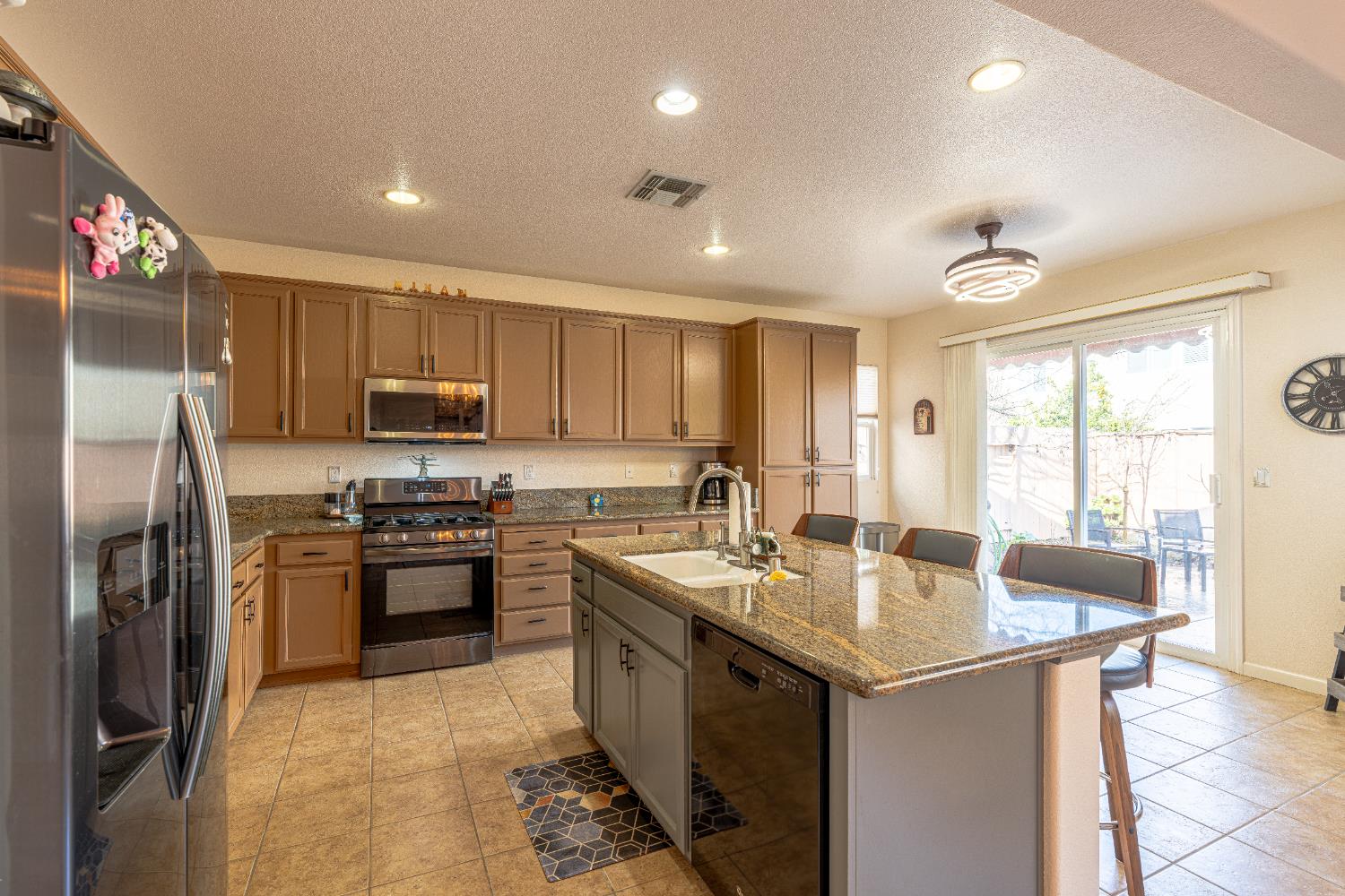 3710 Huntington Road West Sacramento, CA 95691 - Photo 11 of 46 a kitchen with stainless steel appliances granite countertop a sink stove and refrigerator