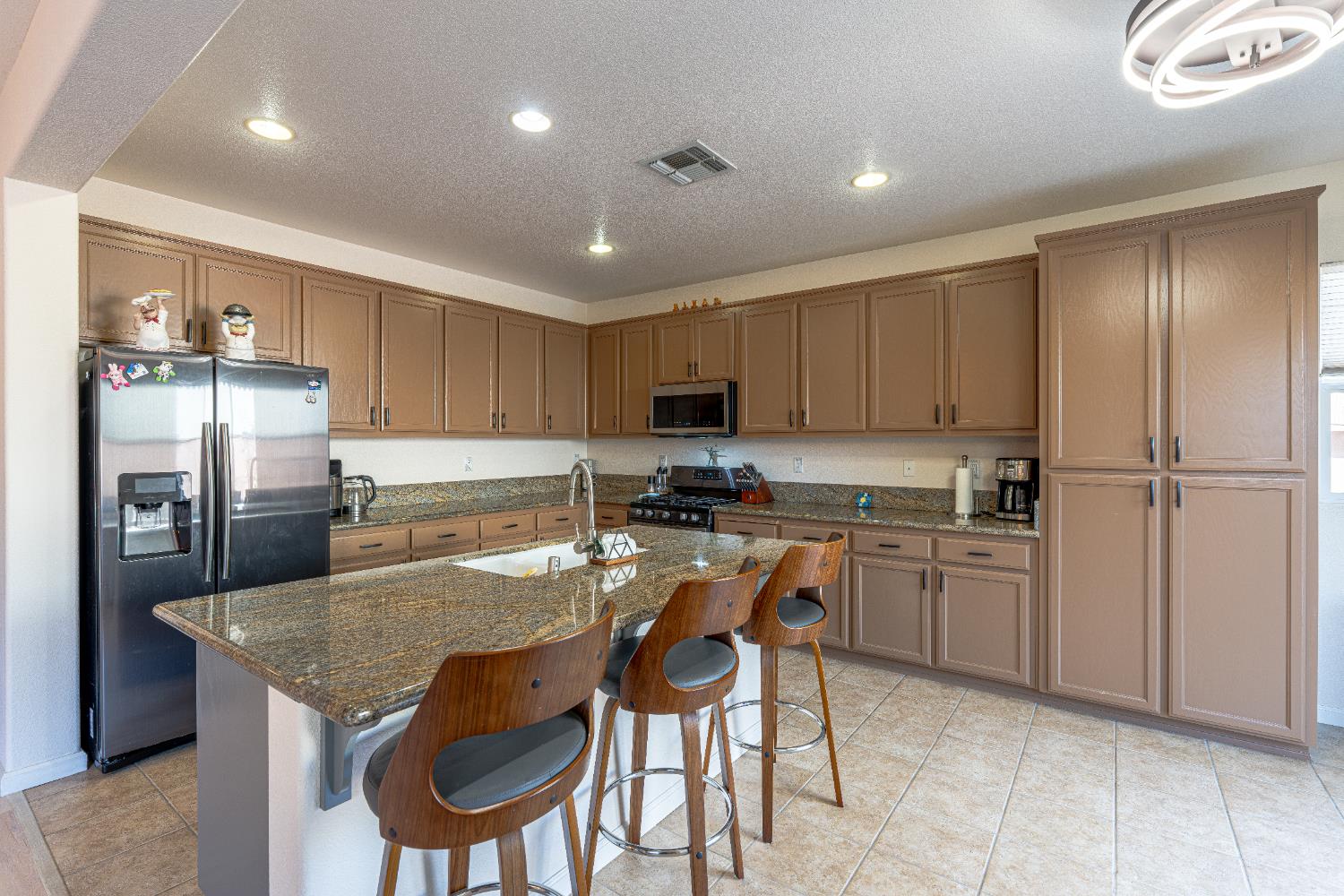 3710 Huntington Road West Sacramento, CA 95691 - Photo 13 of 46 a kitchen with refrigerator a sink and chairs