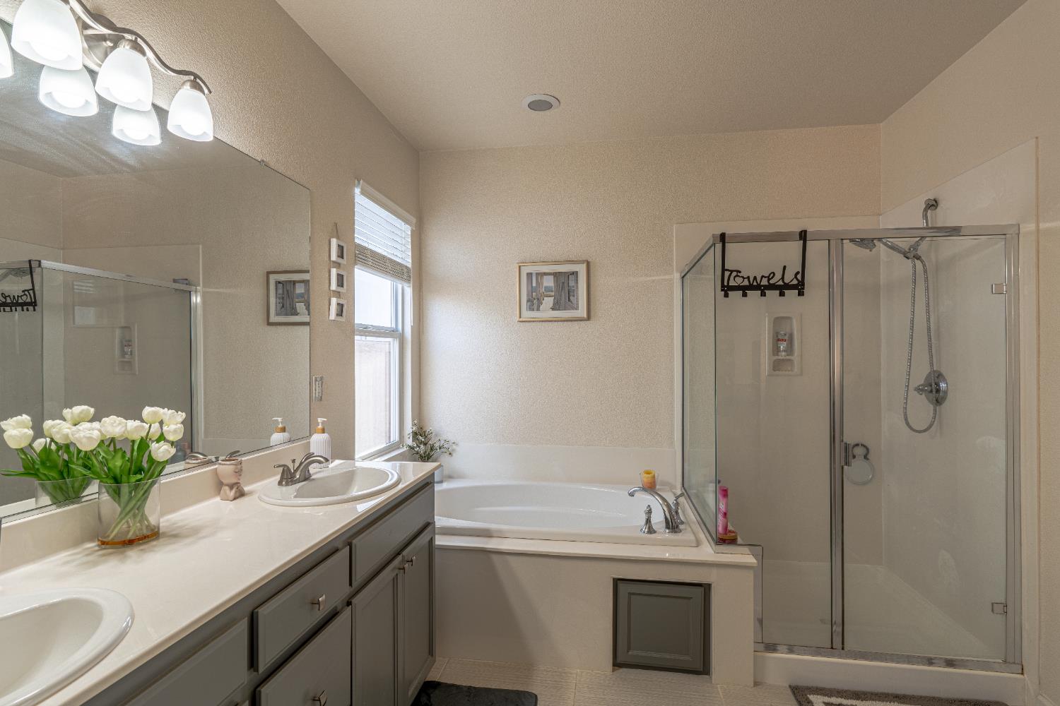 3710 Huntington Road West Sacramento, CA 95691 - Photo 23 of 46 a bathroom with a tub sink vanity granite and shower