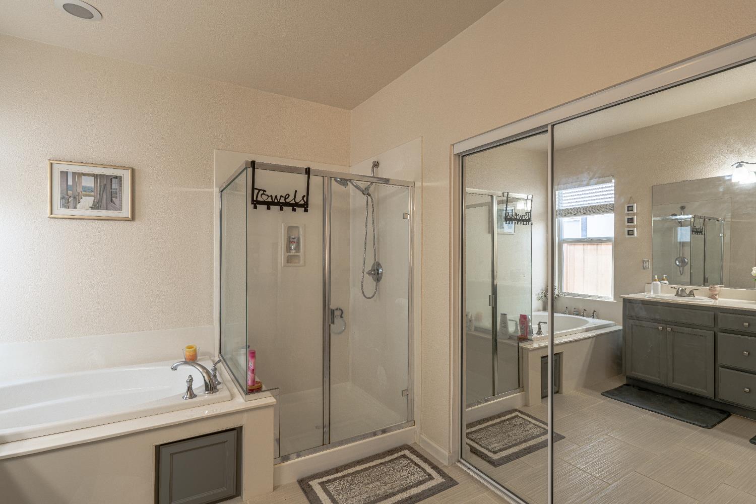 3710 Huntington Road West Sacramento, CA 95691 - Photo 24 of 46 a bathroom with a granite countertop sink a toilet a mirror and shower