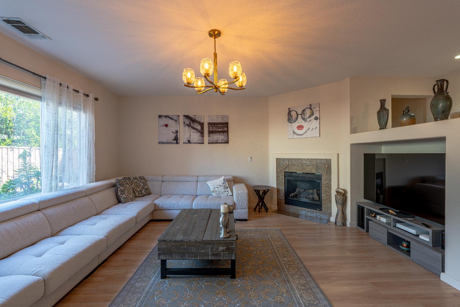 3710 Huntington Road West Sacramento, CA 95691 - Photo 8 of 46 a living room with furniture a flat screen tv and a fireplace