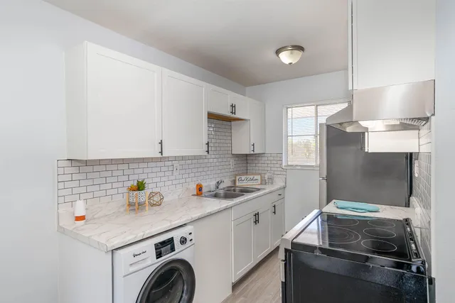 a kitchen that has a sink and a stove