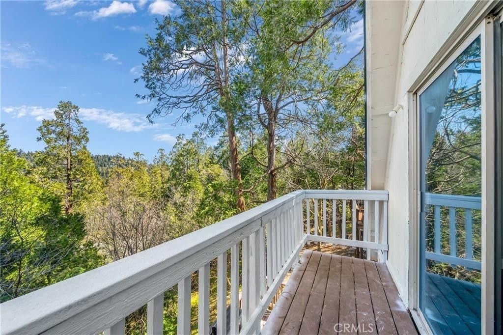 23884 Bowl Road Crestline, CA 92325 - Photo 2 of 9 a view of a balcony with wooden floor