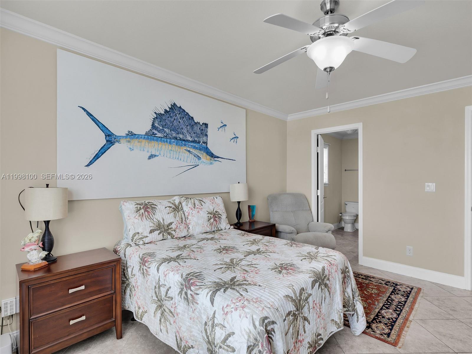 437 Pirates Road Summerland Key, FL 33042 - Photo 25 of 39 a bedroom with a bed and a chandelier