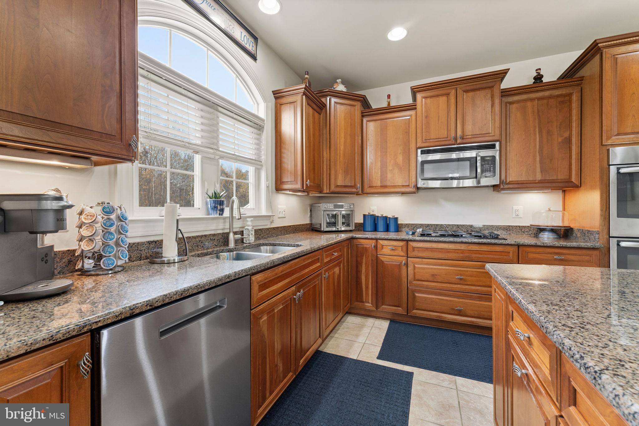 4505 Coachmans Path Court Waldorf, MD 20601 - Photo 21 of 71 a kitchen with stainless steel appliances granite countertop a sink a stove and cabinets