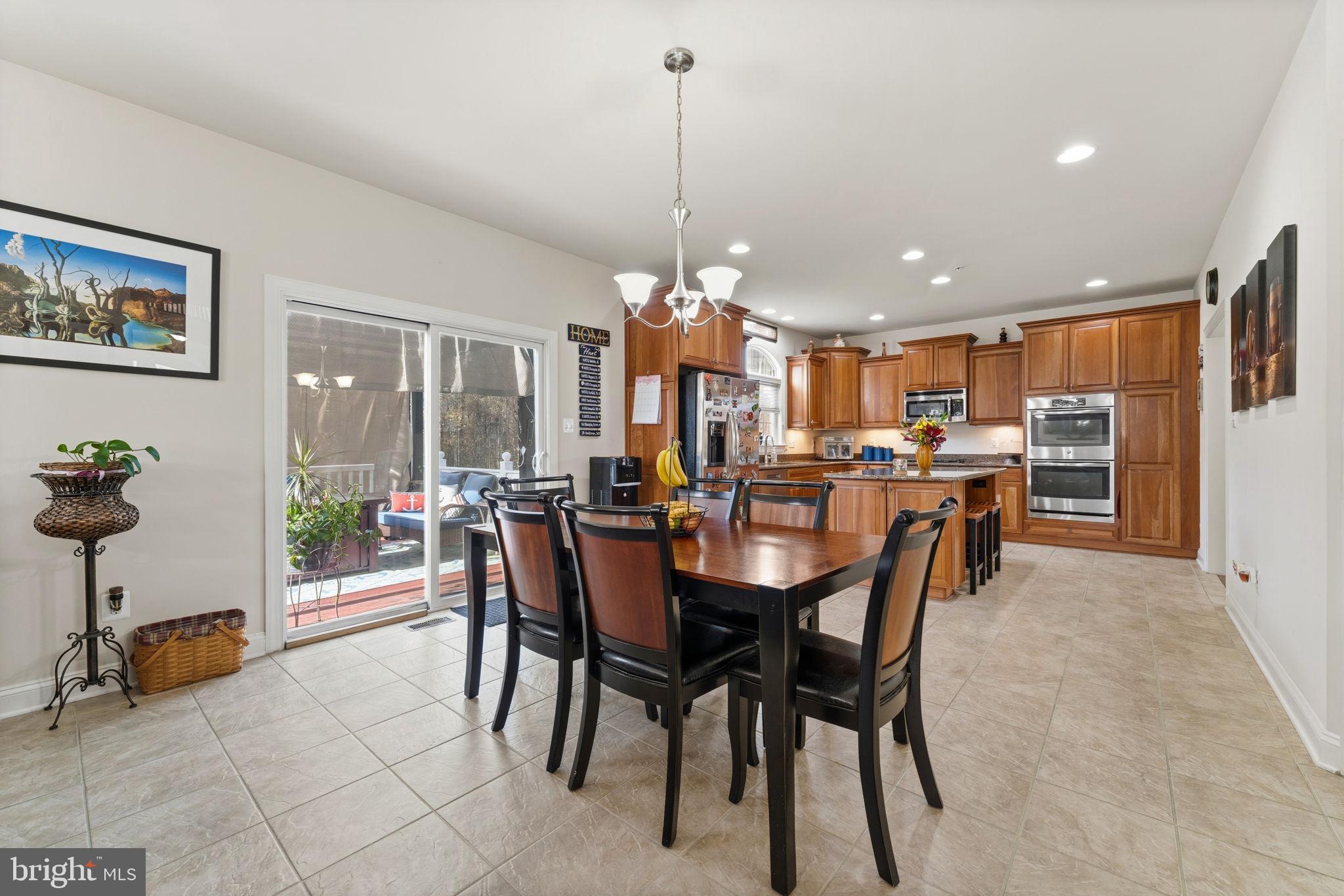 4505 Coachmans Path Court Waldorf, MD 20601 - Photo 24 of 71 a dining room filled with furniture and a chandelier