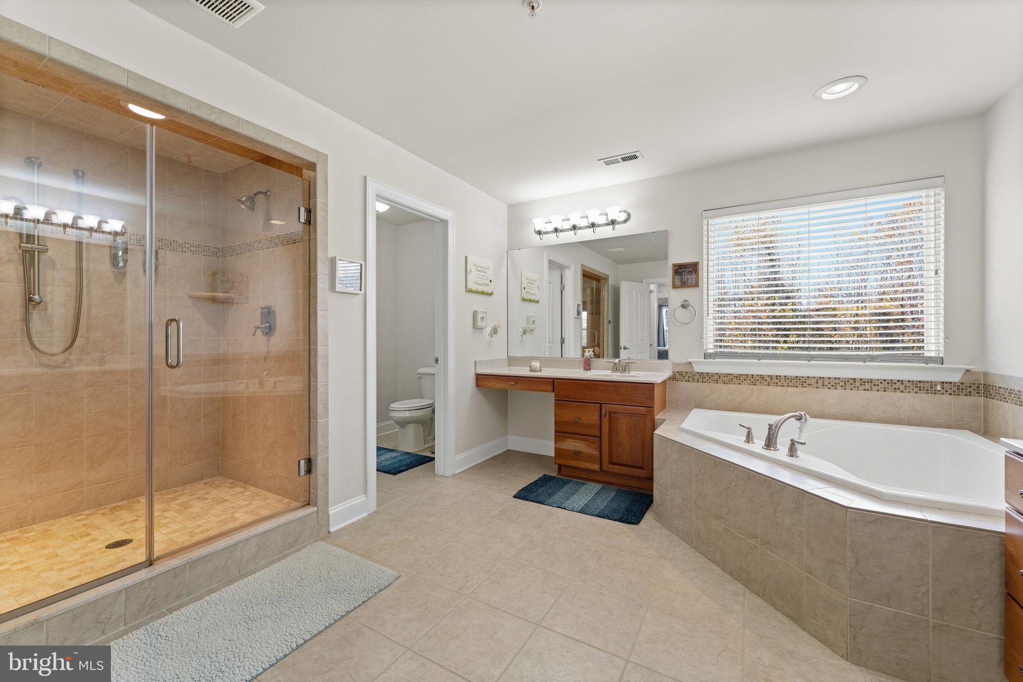 4505 Coachmans Path Court Waldorf, MD 20601 - Photo 32 of 71 a spacious bathroom with a tub shower sink mirror and