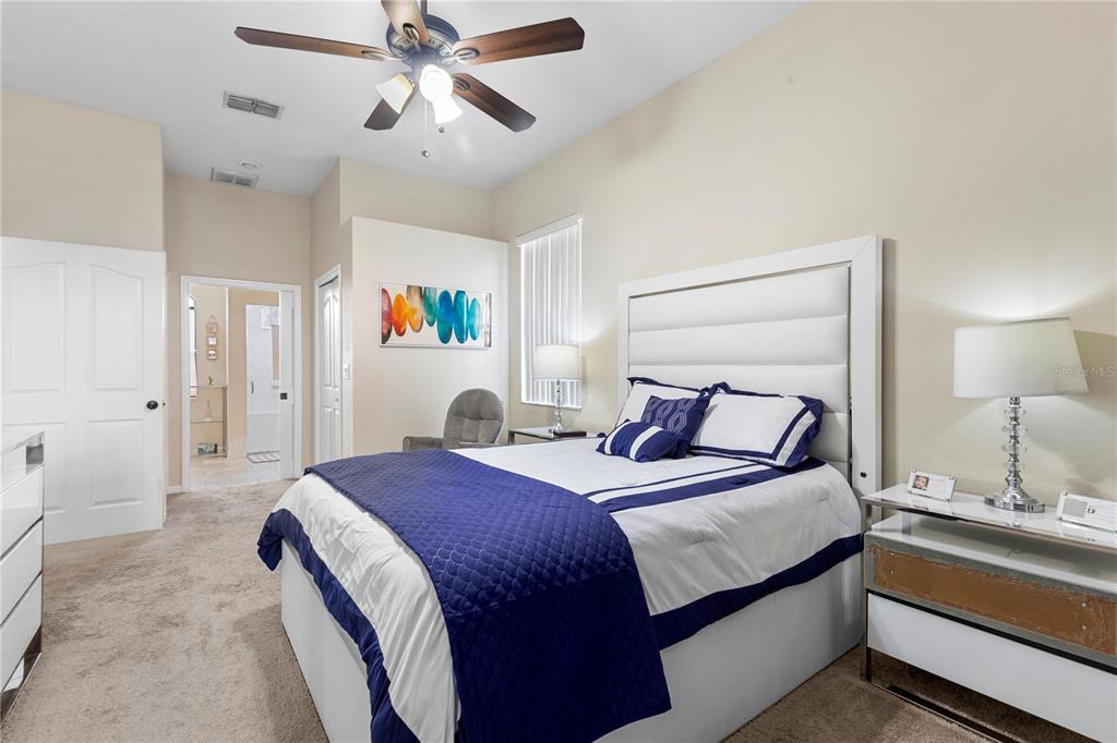 13481 Pullman Drive Spring Hill, FL 34609 - Photo 12 of 41 a bedroom with a bed and a chandelier