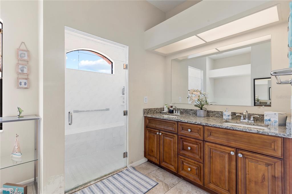 13481 Pullman Drive Spring Hill, FL 34609 - Photo 14 of 41 a spacious bathroom with a double vanity sink and a mirror