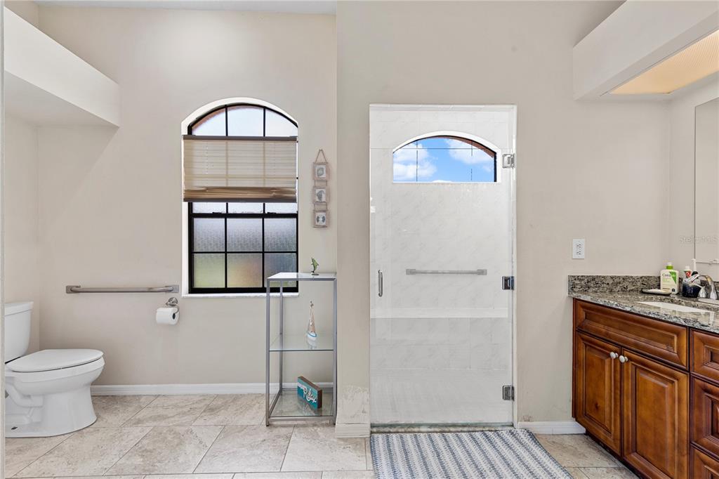 13481 Pullman Drive Spring Hill, FL 34609 - Photo 15 of 41 a bathroom with a toilet a sink and mirror