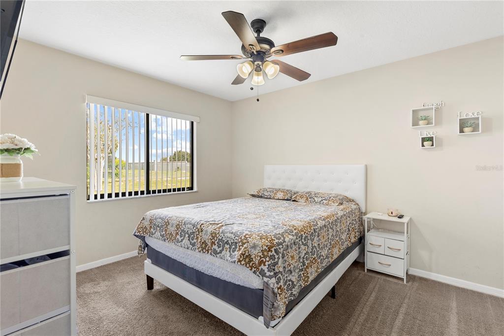 13481 Pullman Drive Spring Hill, FL 34609 - Photo 18 of 41 a bedroom with a bed and a window