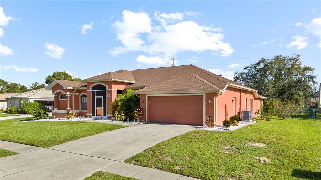 13481 Pullman Drive Spring Hill, FL 34609 - Photo 2 of 41 a front view of a house with a yard and garage