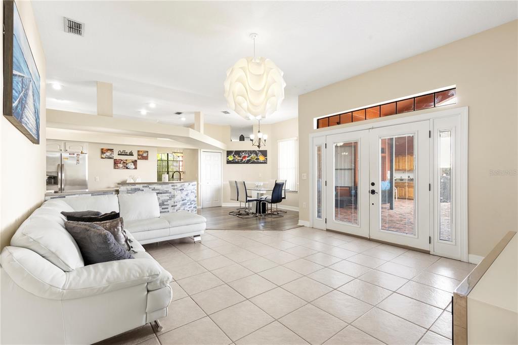 13481 Pullman Drive Spring Hill, FL 34609 - Photo 21 of 41 a living room with furniture and a chandelier