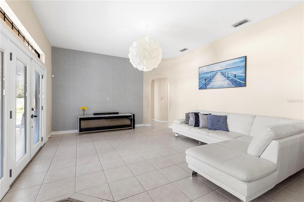 13481 Pullman Drive Spring Hill, FL 34609 - Photo 22 of 41 a living room with furniture and a chandelier