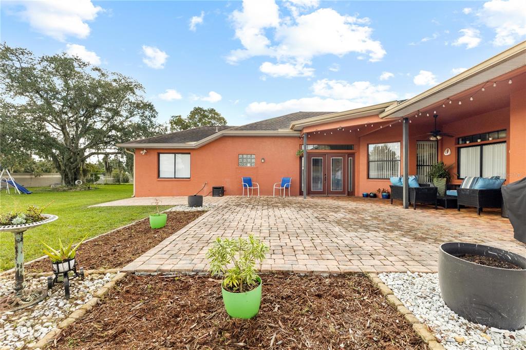 13481 Pullman Drive Spring Hill, FL 34609 - Photo 32 of 41 a front view of a house with a yard and outdoor seating