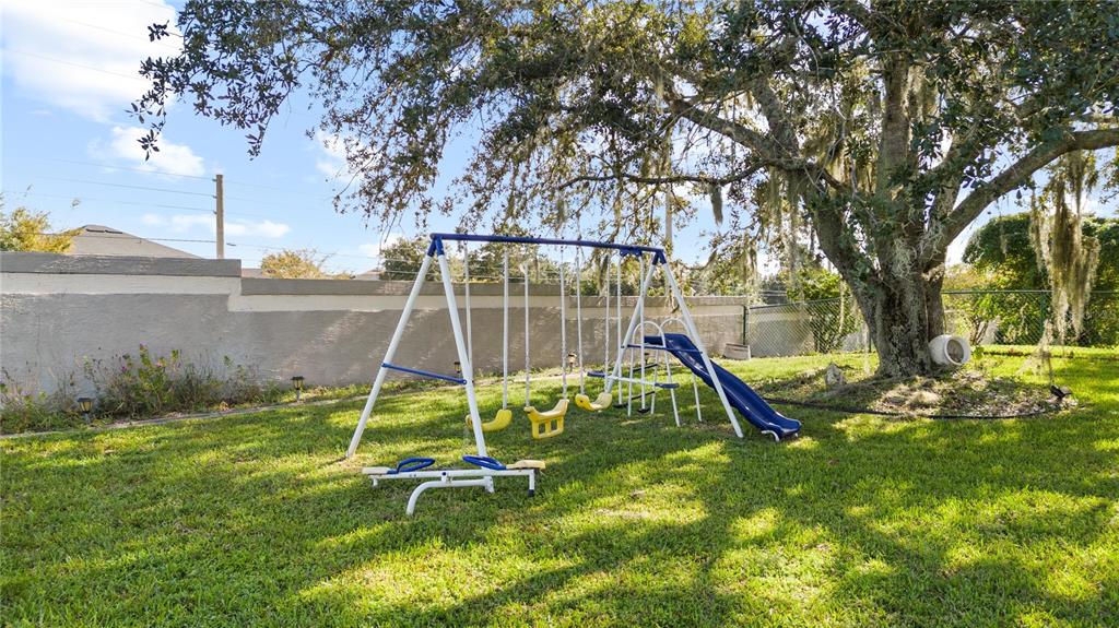 13481 Pullman Drive Spring Hill, FL 34609 - Photo 40 of 41 a view of a backyard with a slide