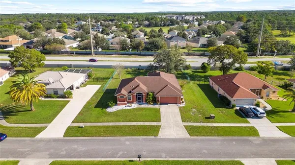 an aerial view of residential houses with outdoor space and swimming pool