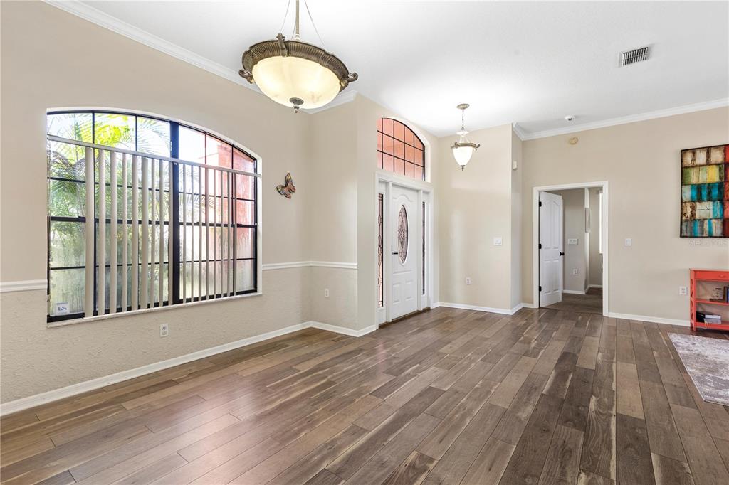 13481 Pullman Drive Spring Hill, FL 34609 - Photo 8 of 41 a view of an empty room with wooden floor and a window