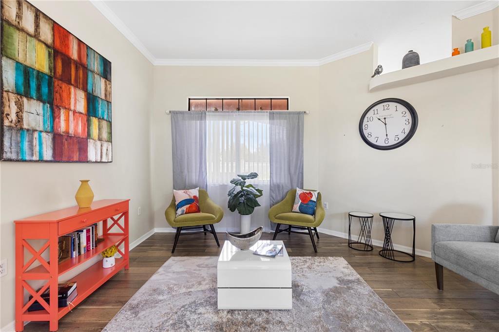 13481 Pullman Drive Spring Hill, FL 34609 - Photo 10 of 41 a living room with furniture and a clock
