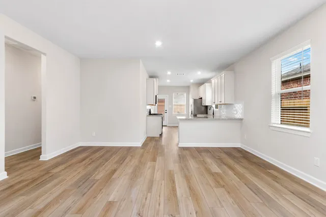 a view of a kitchen with wooden floor