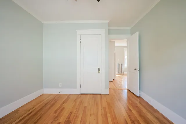 a view of an empty room and wooden floor